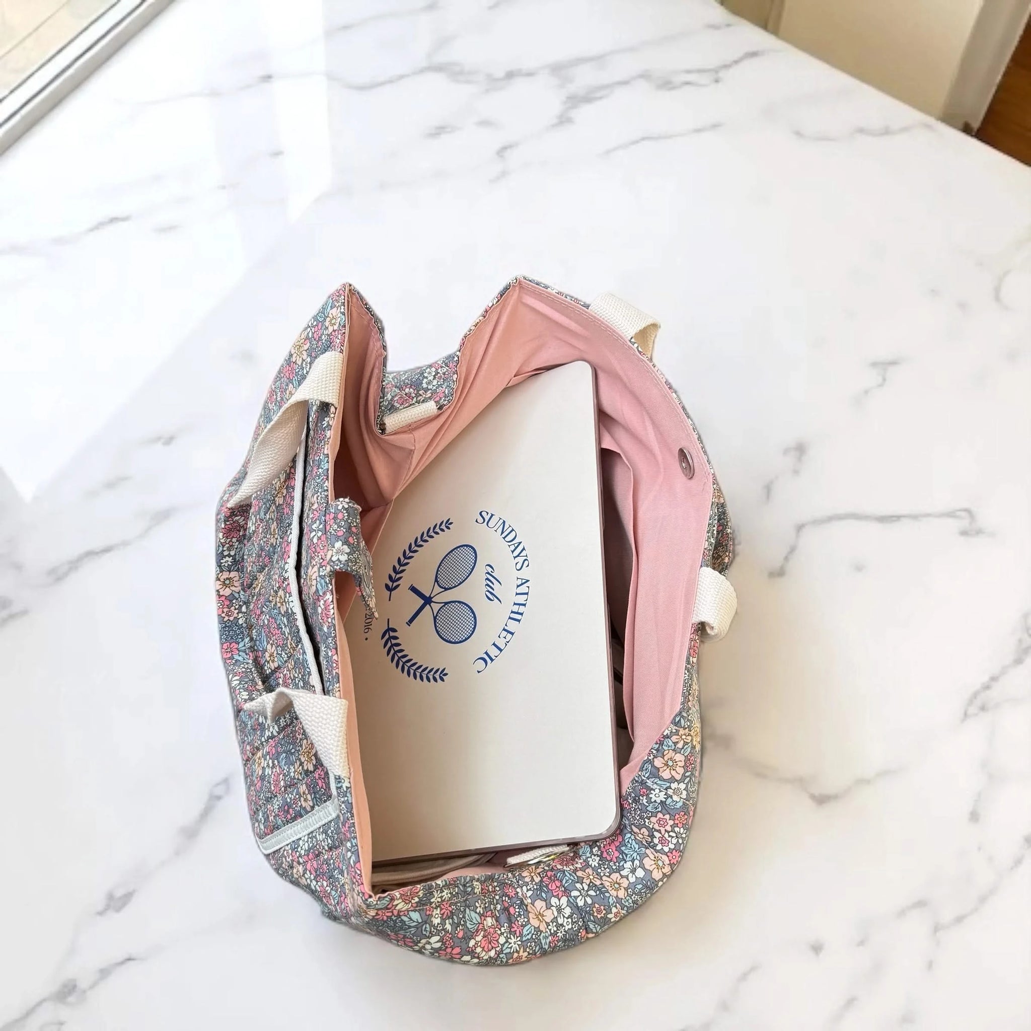 Josh & Tate - Blossom Tote Bag - Floral-patterned shoe bag with a white shoe inside on a marble surface