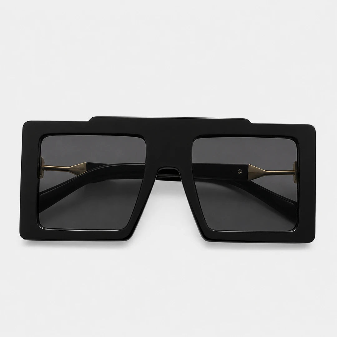 Josh & Tate - BoldFrame™ Square Glasses - Black oversized square sunglasses with dark lenses and gold metal bridge details, shown from a top-down view on a light gray background.