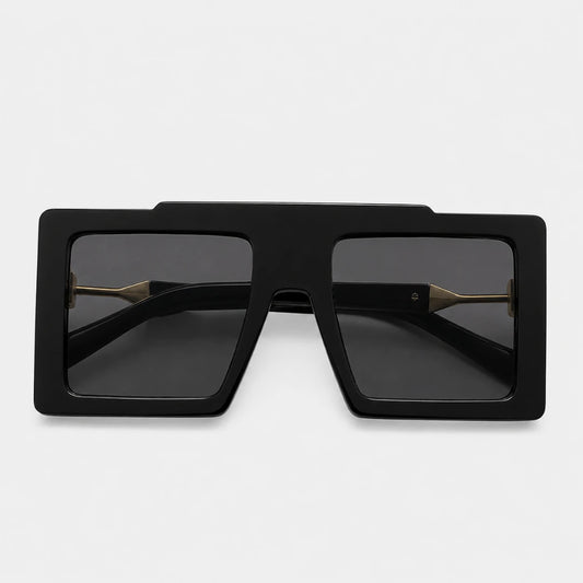Josh & Tate - BoldFrame™ Square Glasses - Black oversized square sunglasses with dark lenses and gold metal bridge details, shown from a top-down view on a light gray background.