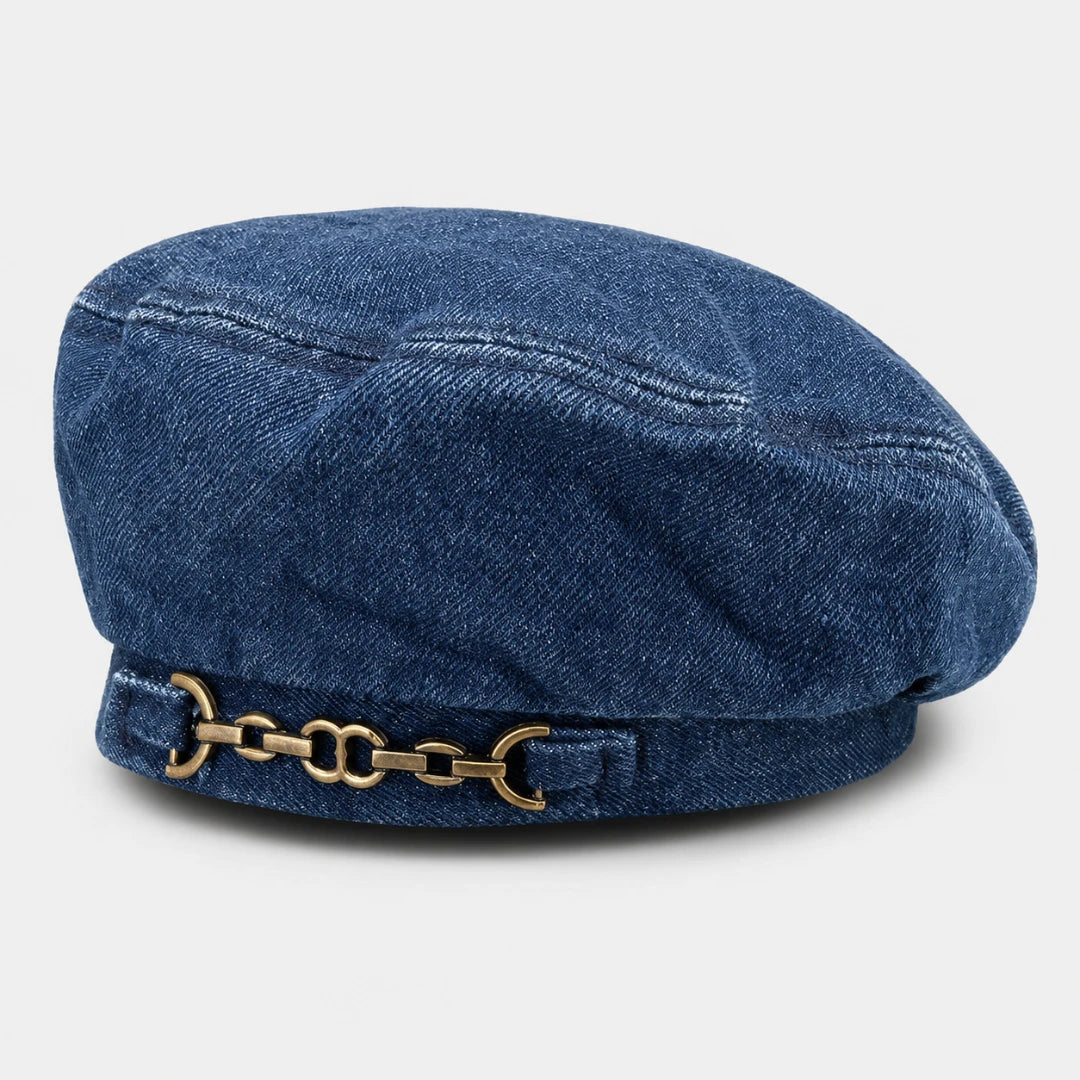 Josh & Tate - BrixChain™ Washed Denim Beret - A blue denim newsboy cap featuring a decorative gold-tone horsebit chain detail on the front of the brim, set against a light gray background.