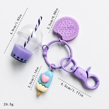Josh & Tate - BubbleBite™ Milk Tea Keychain - A purple silicone keychain bag set featuring a drink cup charm with a striped straw, a biscuit-shaped bag, and an ice cream cone charm, shown with dimension lines and weight text on a white background.