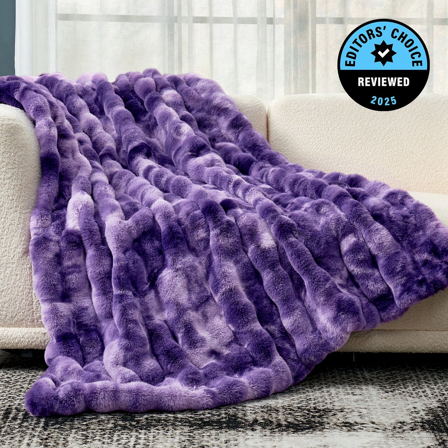 Purple textured blanket draped over a couch with 'Editors' Choice' badge.