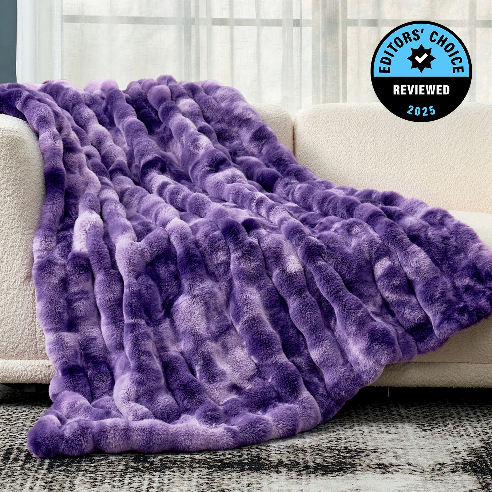 Purple textured blanket draped over a couch with 'Editors' Choice' badge.
