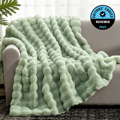Green textured blanket draped over a couch with 'Editors' Choice' badge in the corner.