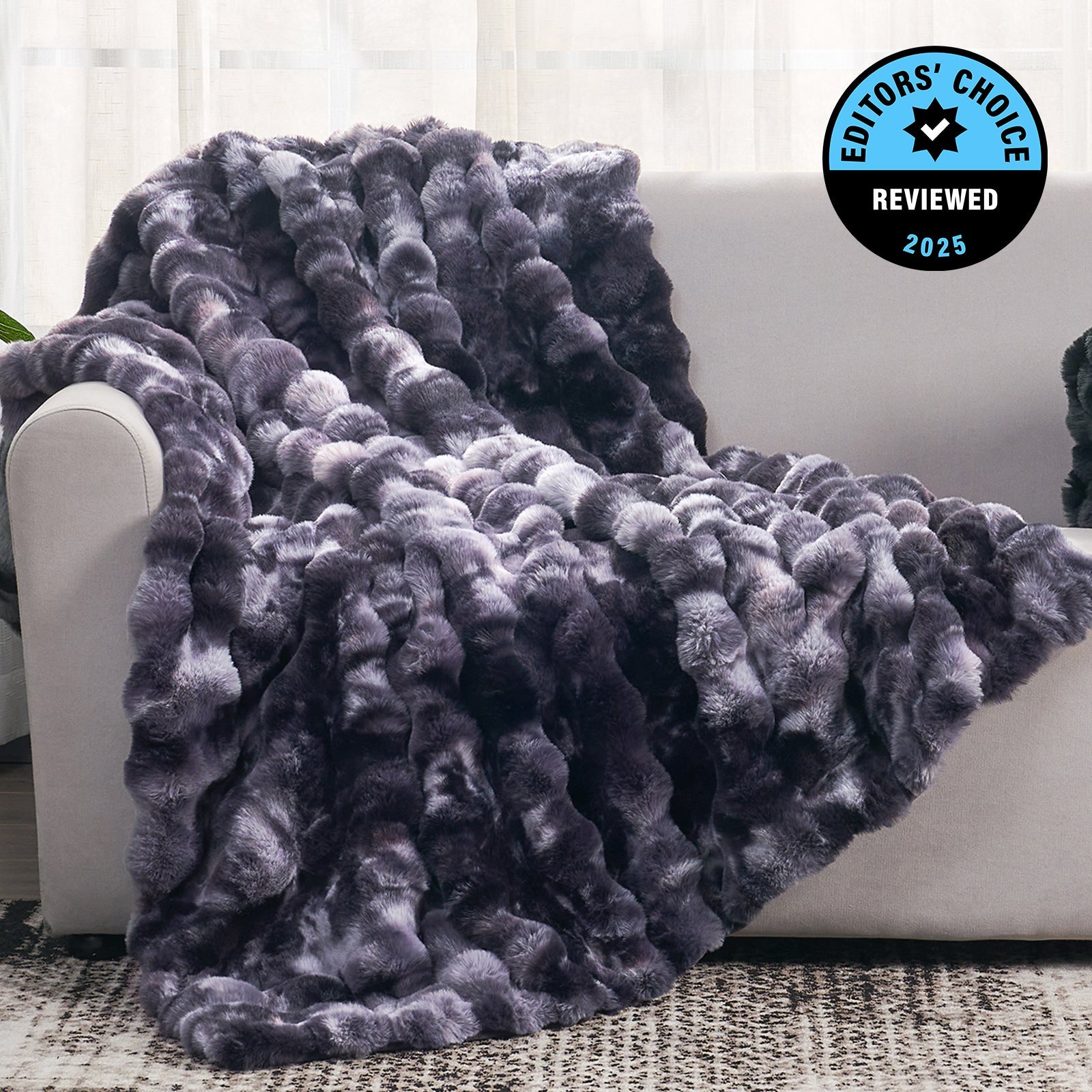 Gray textured blanket draped over a white couch with 'Editors' Choice' badge in the corner.