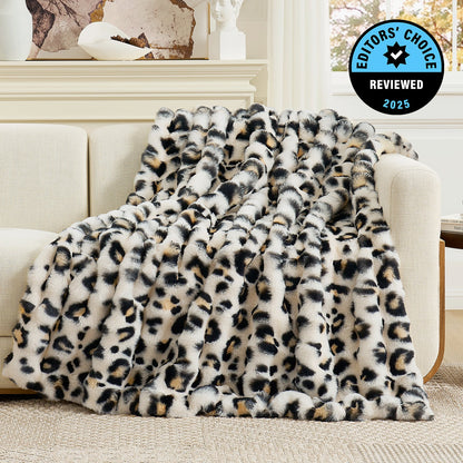 Leopard print blanket draped over a sofa with 'Editors' Choice' badge in the corner.