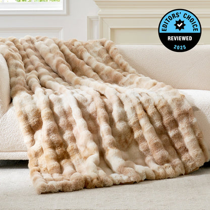 Beige textured blanket draped over a couch with 'Editors' Choice' badge in the corner.