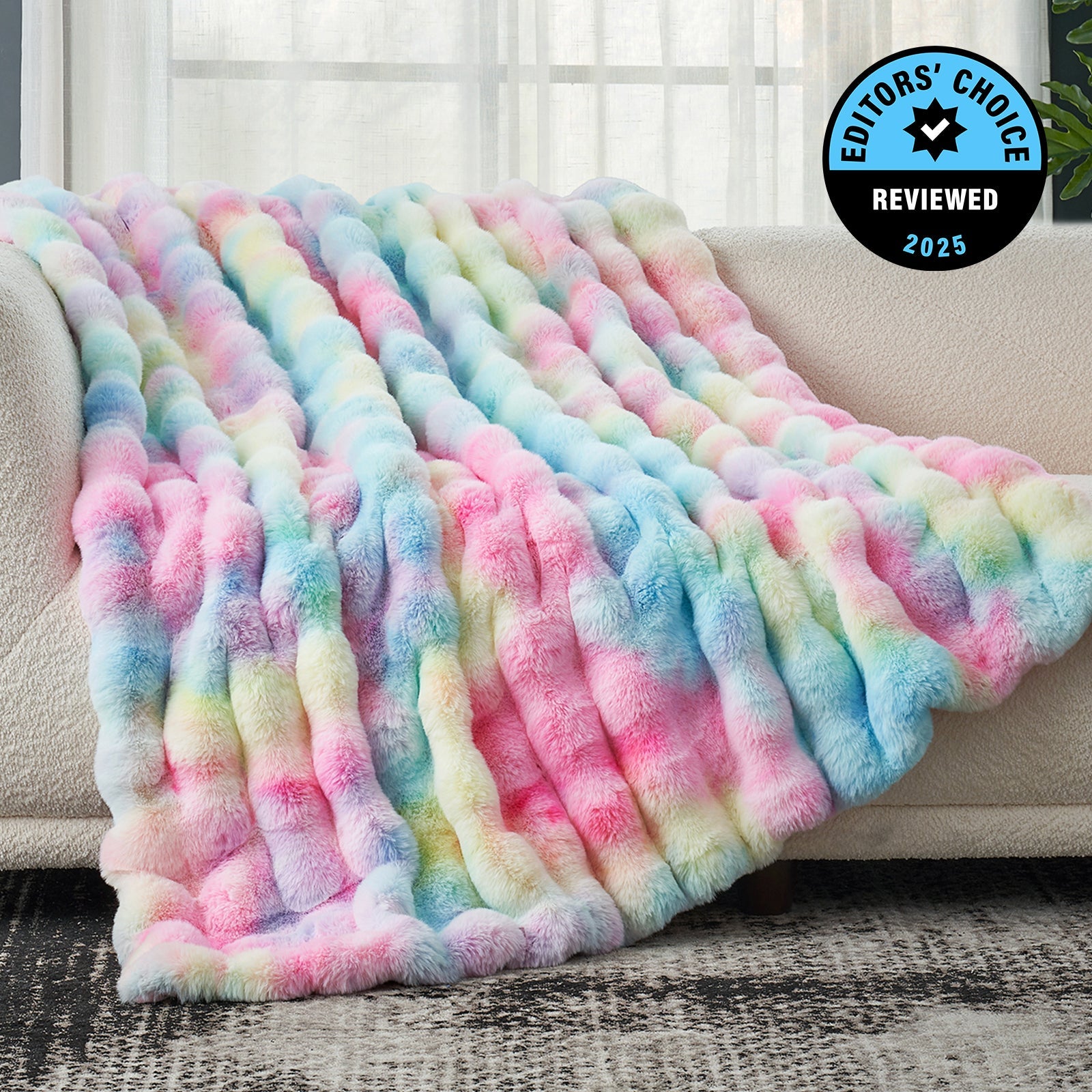 Multicolored fleece blanket draped over a couch with 'Editors' Choice' badge.