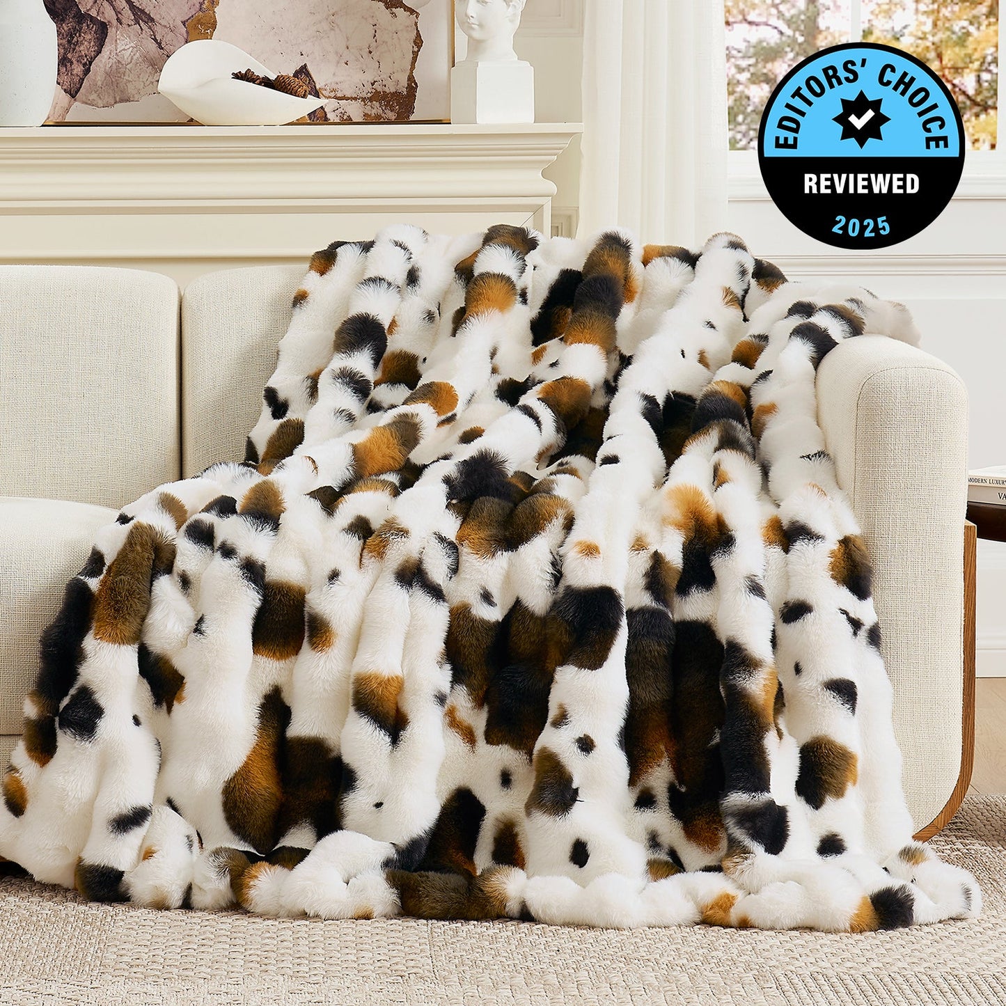 Patterned blanket draped over a sofa with 'Editors' Choice' badge in the corner.