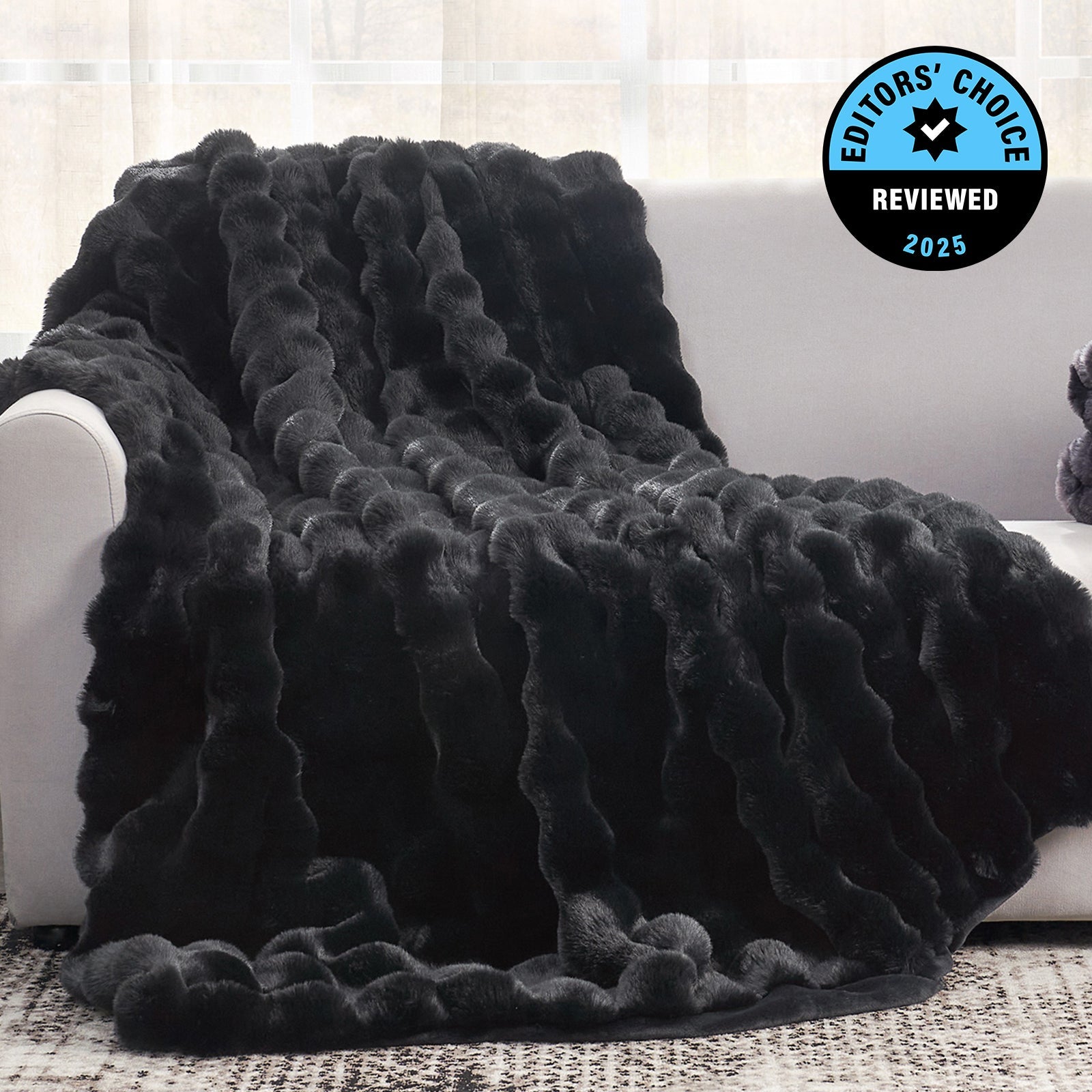 Black textured blanket draped over a white couch with 'Editors' Choice' badge.