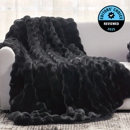 Black textured blanket draped over a white couch with 'Editors' Choice' badge.
