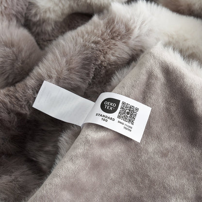 Gray fur fabric with an OEKO-TEX label on a close-up view