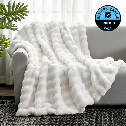 White fluffy blanket draped over a sofa with an 'Editors' Choice' badge in the corner.