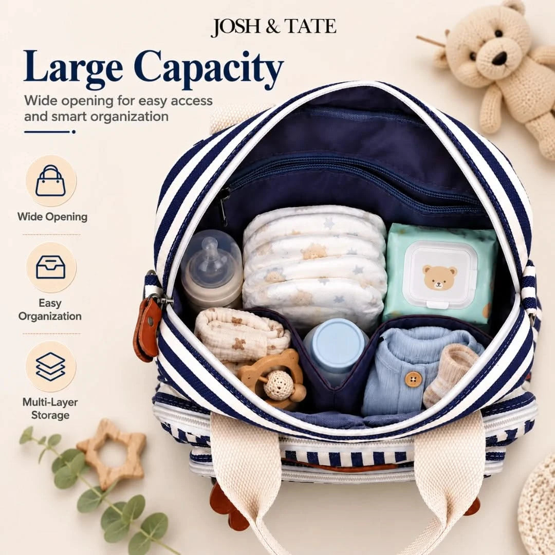 Josh & Tate - CarryAll™ Convertible Baby Bag - Baby diaper bag with baby items and 'Josh & Tate' branding on a light background