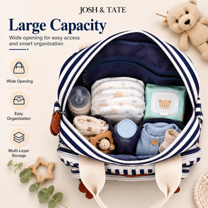 Josh & Tate - CarryAll™ Convertible Baby Bag - Baby diaper bag with baby items and 'Josh & Tate' branding on a light background