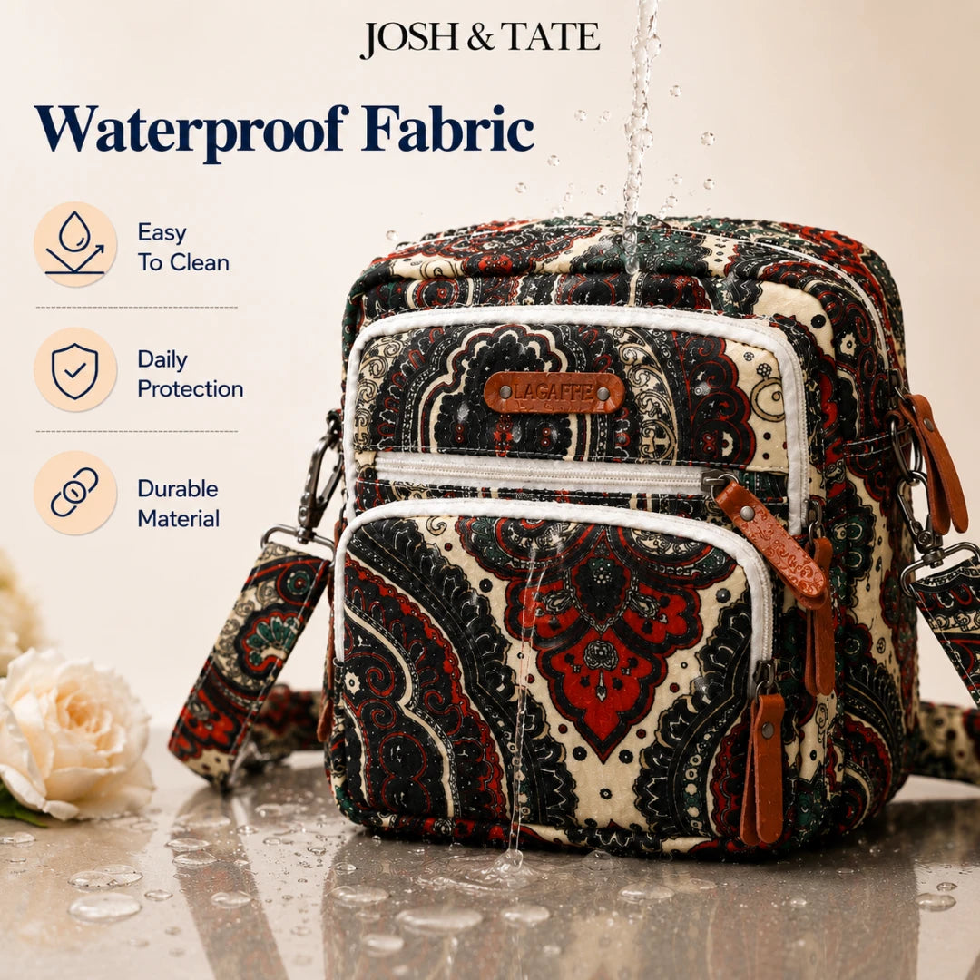 Josh & Tate - CarryAll™ Convertible Baby Bag - Patterned bag with Josh & Tate branding, shown with water splashing over it.
