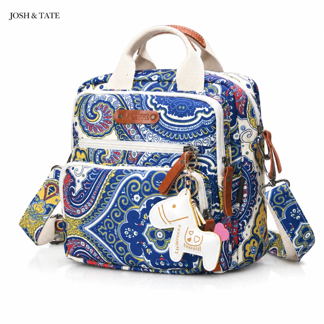 Josh & Tate - CarryAll™ Convertible Baby Bag - Colorful patterned backpack with a keychain on a white background