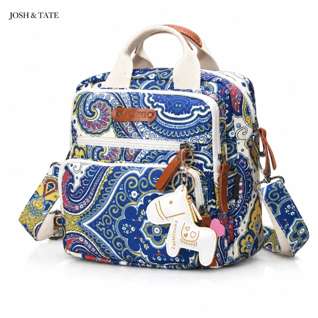 Josh & Tate - CarryAll™ Convertible Baby Bag - Colorful patterned backpack with a keychain on a white background