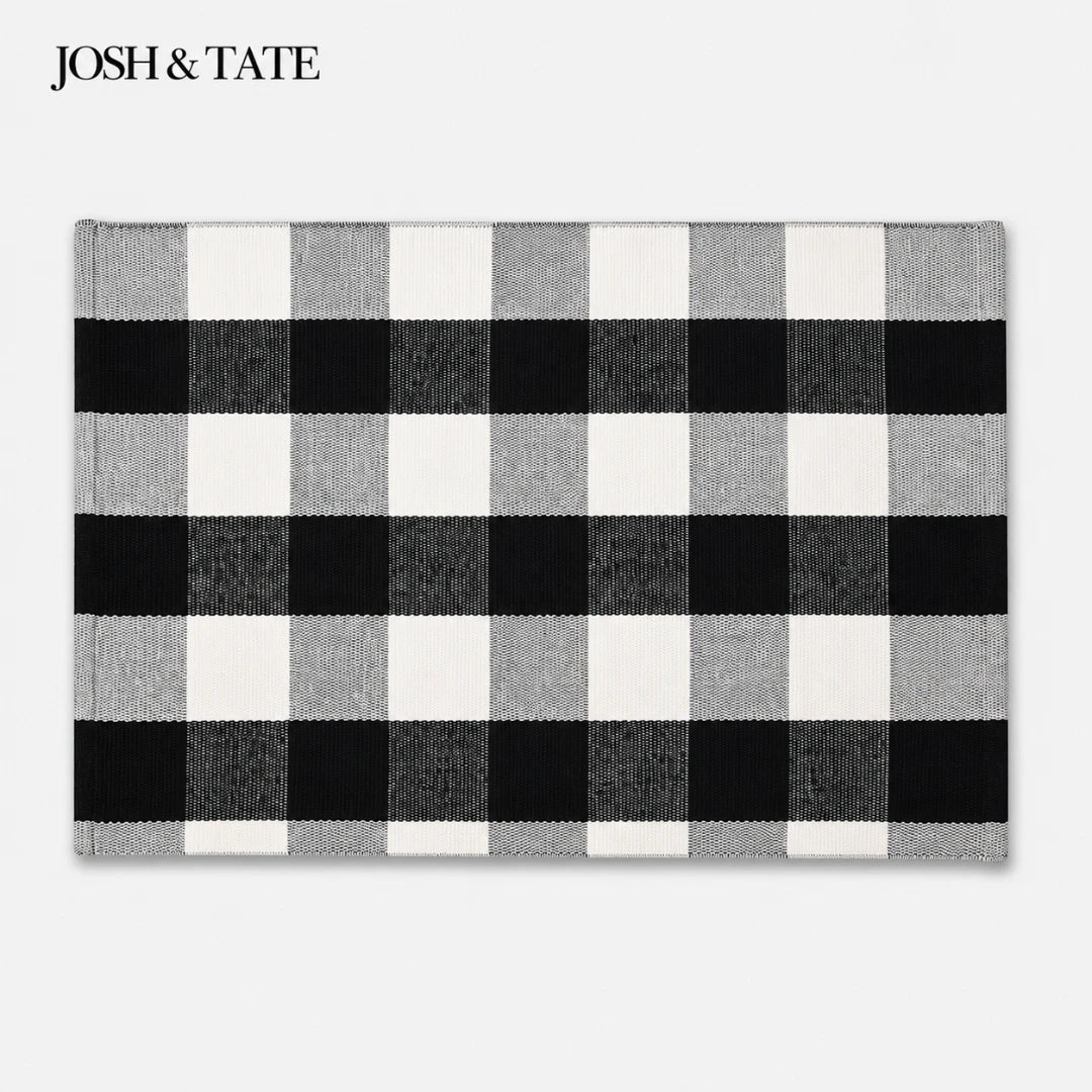Josh & Tate - CheckMate™ Buffalo Plaid Cotton Rug - Black and white checkered rug with 'JOSH & TATE' branding on a light gray background