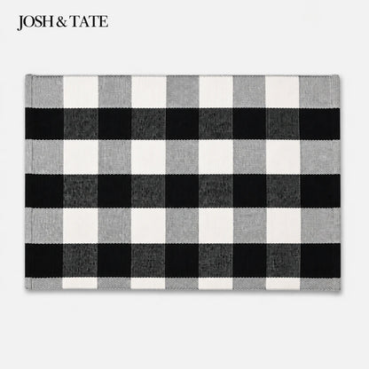 Josh & Tate - CheckMate™ Buffalo Plaid Cotton Rug - Black and white checkered rug with 'JOSH & TATE' branding on a light gray background