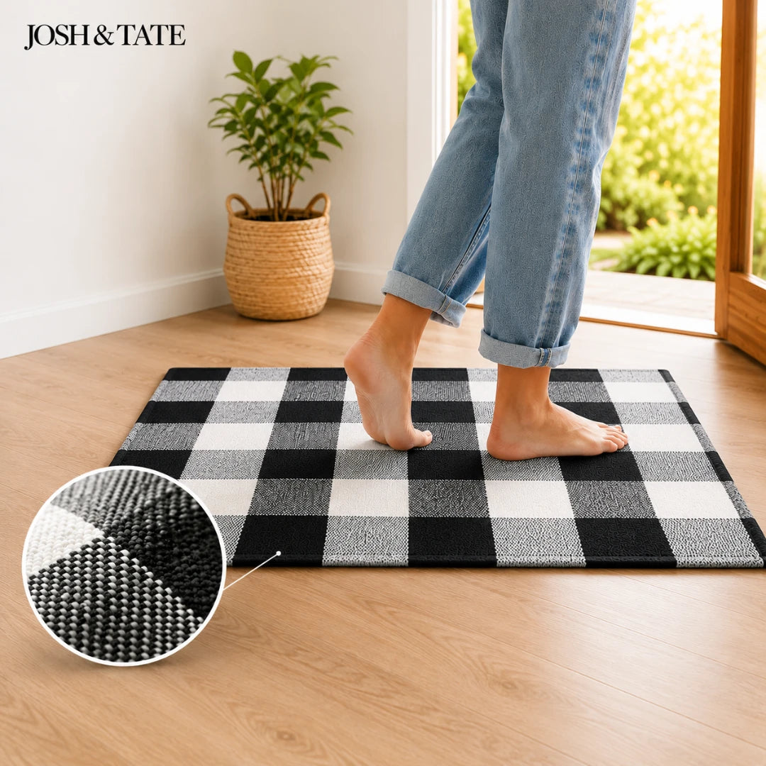 Josh & Tate - CheckMate™ Buffalo Plaid Cotton Rug - Person stepping onto a black and white checkered rug with 'Josh & Tate' branding.