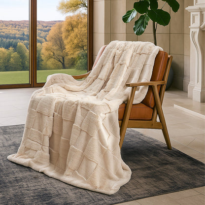 Beige blanket draped over a brown chair in a room with a view of trees outside.