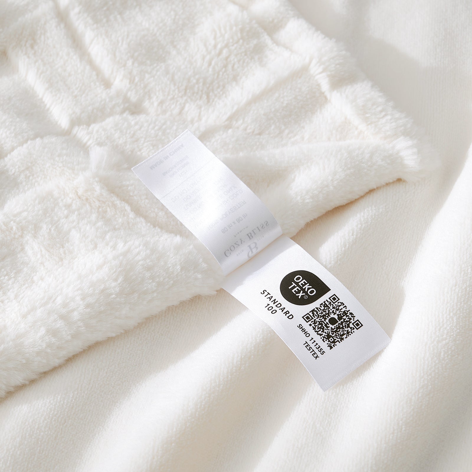 Close-up of a white fabric with a label on a white background