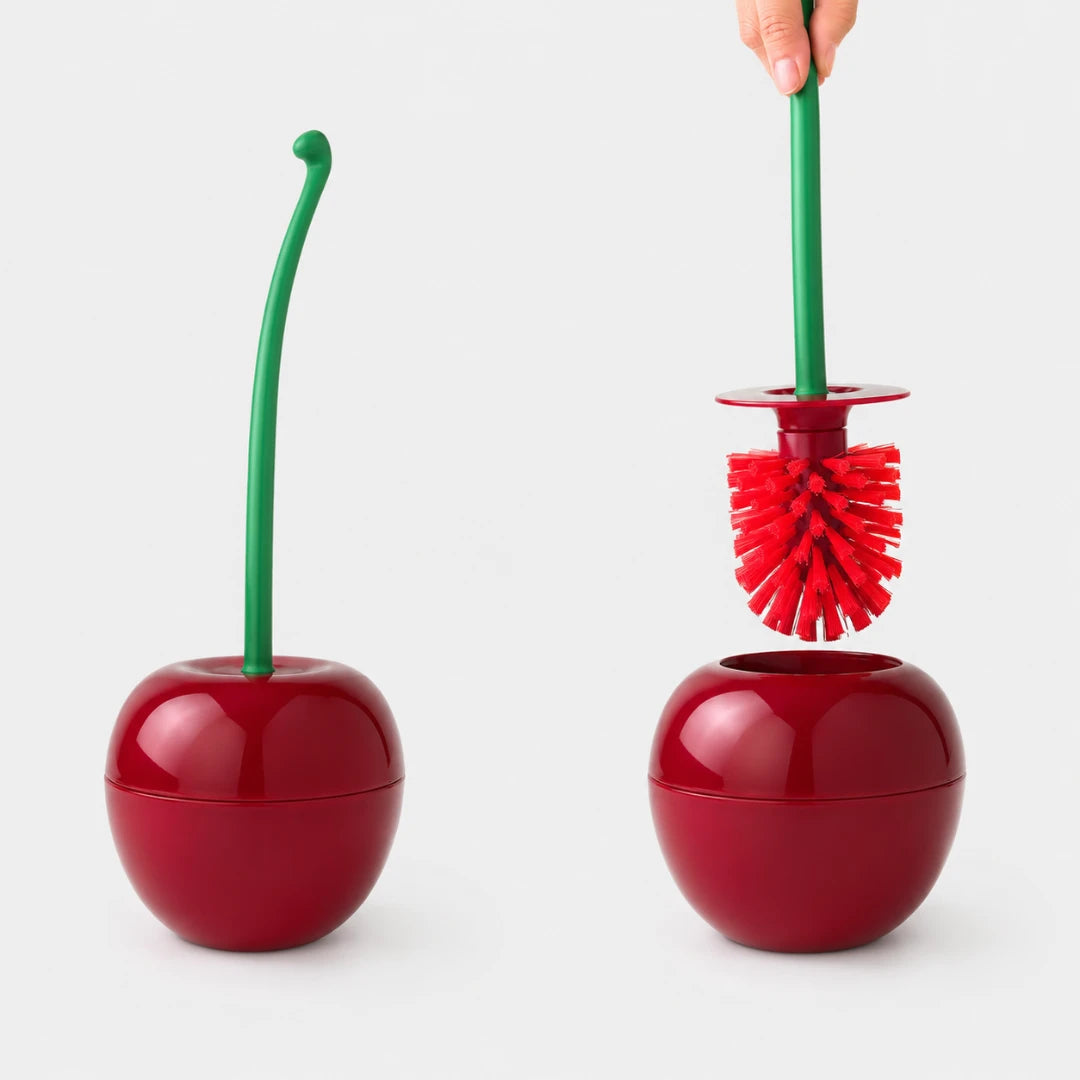 Josh & Tate - CherryPop™ Toilet Brush & Holder - A cherry-shaped toilet brush set shown in two views on a light gray background: one closed with a green stem and one open with a hand holding the green handle, revealing red bristles.