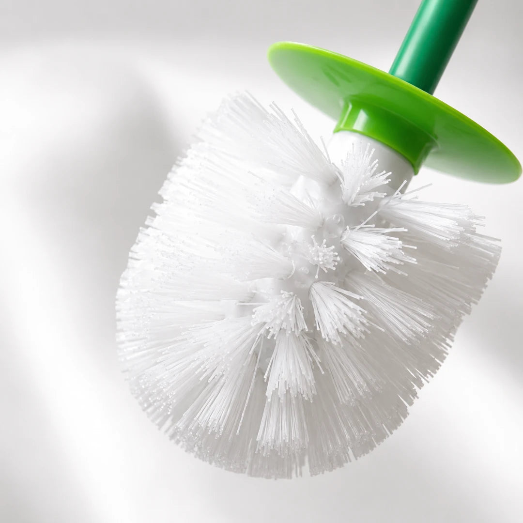 Josh & Tate - CherryPop™ Toilet Brush & Holder - A close-up of a toilet brush with white bristles, a green plastic collar, and a green handle against a soft white background.