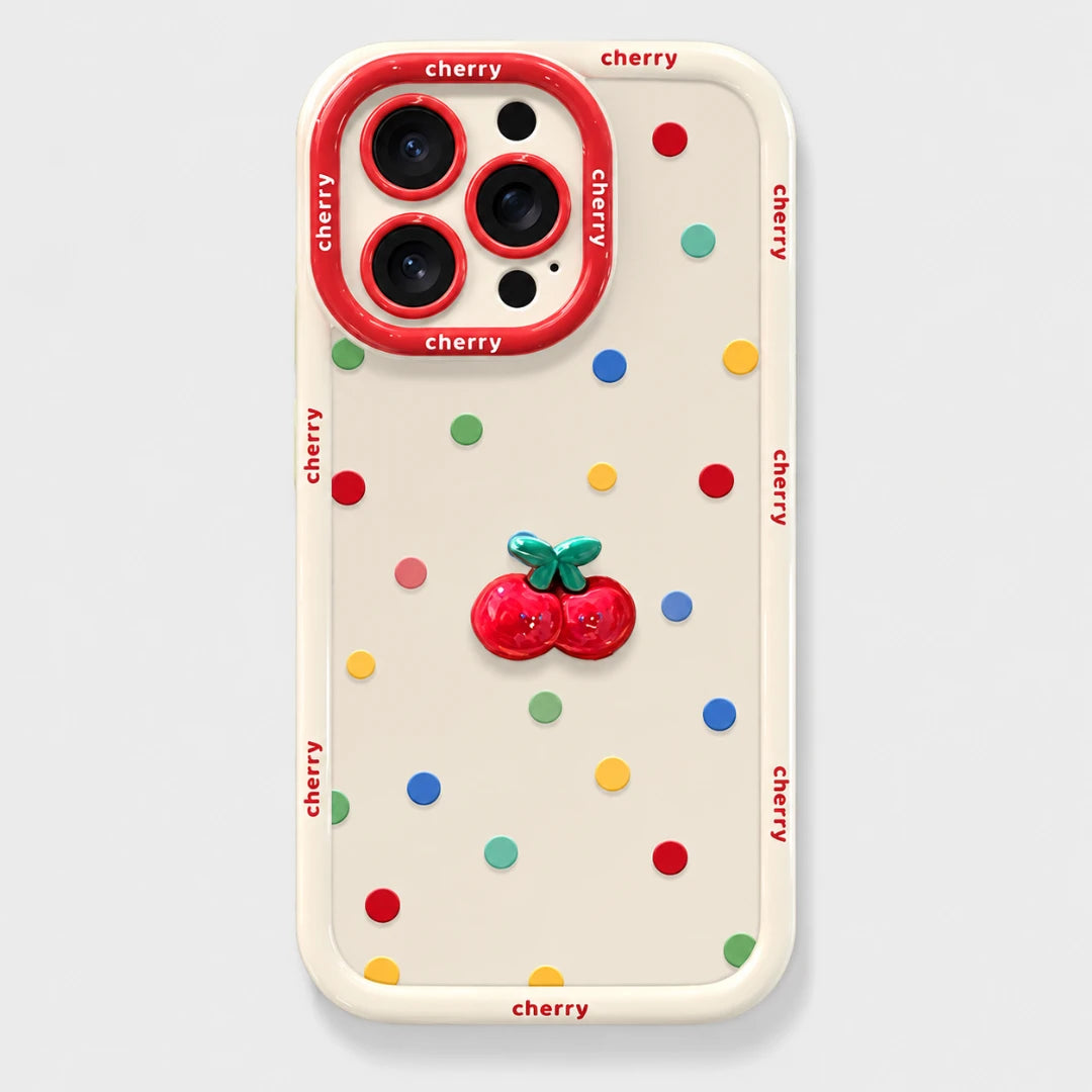 Josh & Tate - CherryPop™ iPhone Case - A cream-colored phone case with a colorful cherry-themed design, featuring a 3D red cherry embellishment in the center, multicolored confetti dots, and 'cherry' printed in red along the border and around the camera ring.