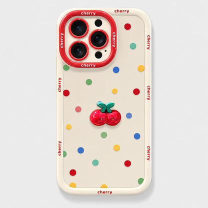 Josh & Tate - CherryPop™ iPhone Case - A cream-colored phone case with a colorful cherry-themed design, featuring a 3D red cherry embellishment in the center, multicolored confetti dots, and 'cherry' printed in red along the border and around the camera ring.