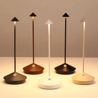 Set of five modern desk lamps with different base colors on a neutral background