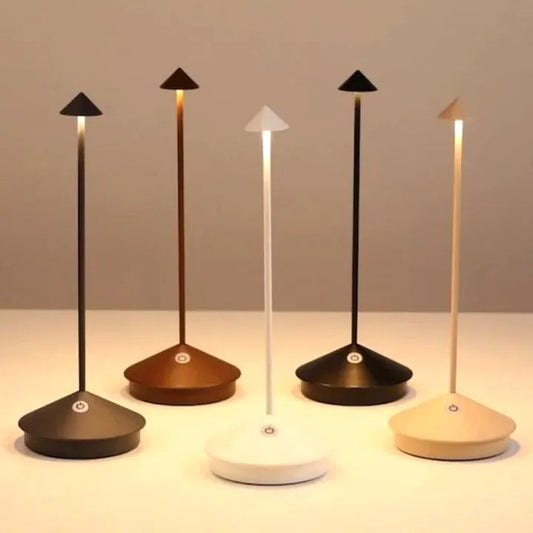 Set of five modern desk lamps with different base colors on a neutral background