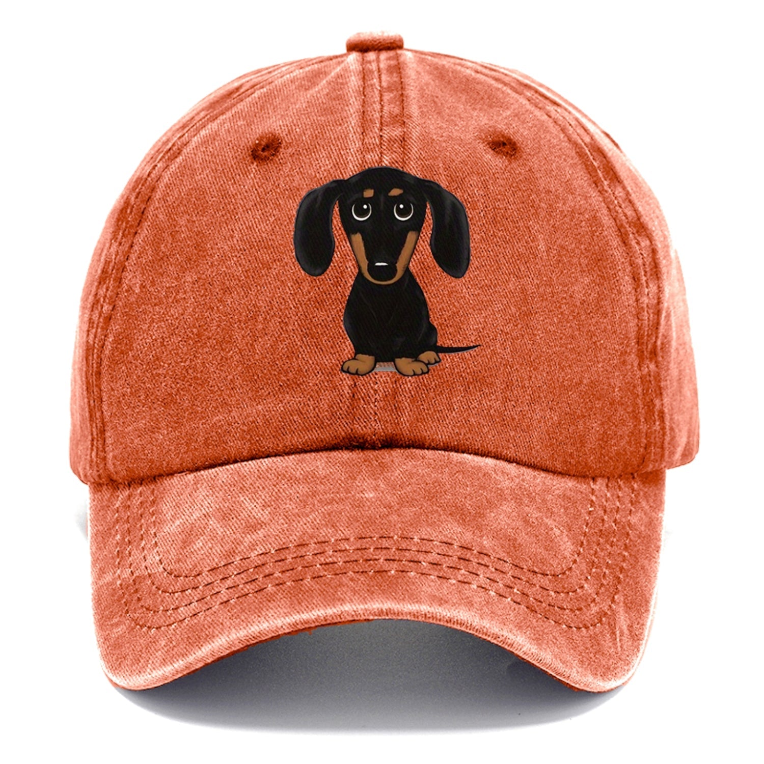 Orange cap with a dachshund illustration on a white background