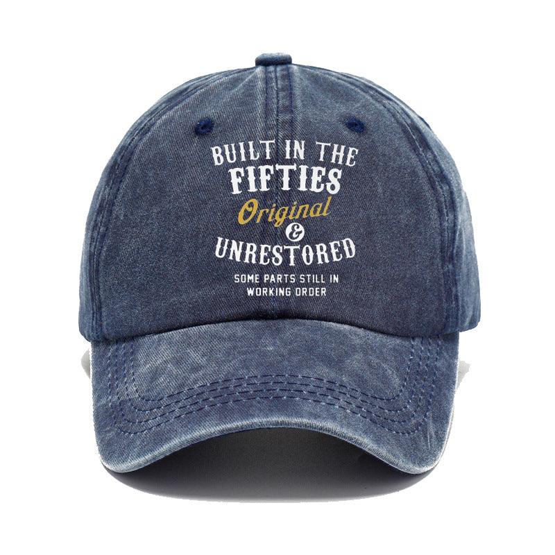 Blue denim cap with text 'Built in the Fifties, Original & Unrestored' on a white background