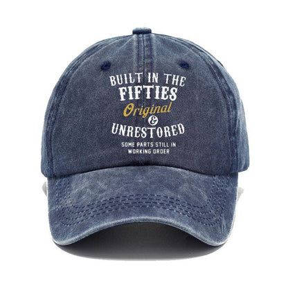 Blue denim cap with text 'Built in the Fifties, Original & Unrestored' on a white background