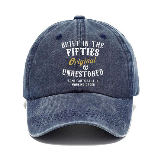 Blue denim cap with text 'Built in the Fifties, Original & Unrestored' on a white background