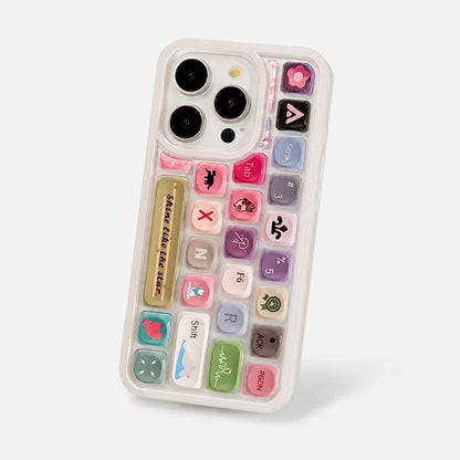 Josh & Tate - ClickPod™ Keycap Phone Case - A clear phone case featuring a colorful retro calculator keyboard design with various pastel-colored buttons and decorative icons, shown on a light gray background.