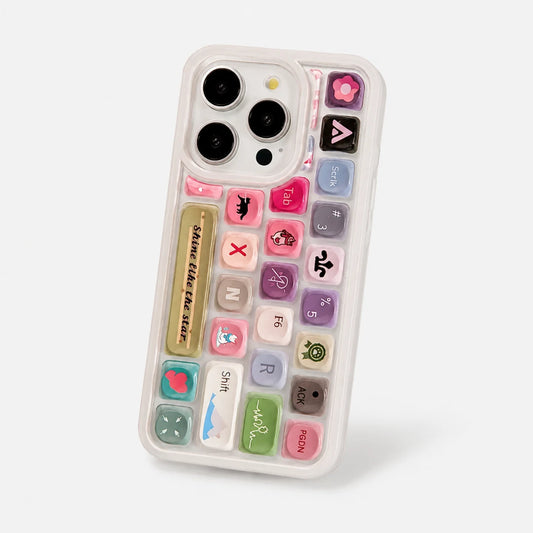 Josh & Tate - ClickPod™ Keycap Phone Case - A clear phone case featuring a colorful retro calculator keyboard design with various pastel-colored buttons and decorative icons, shown on a light gray background.
