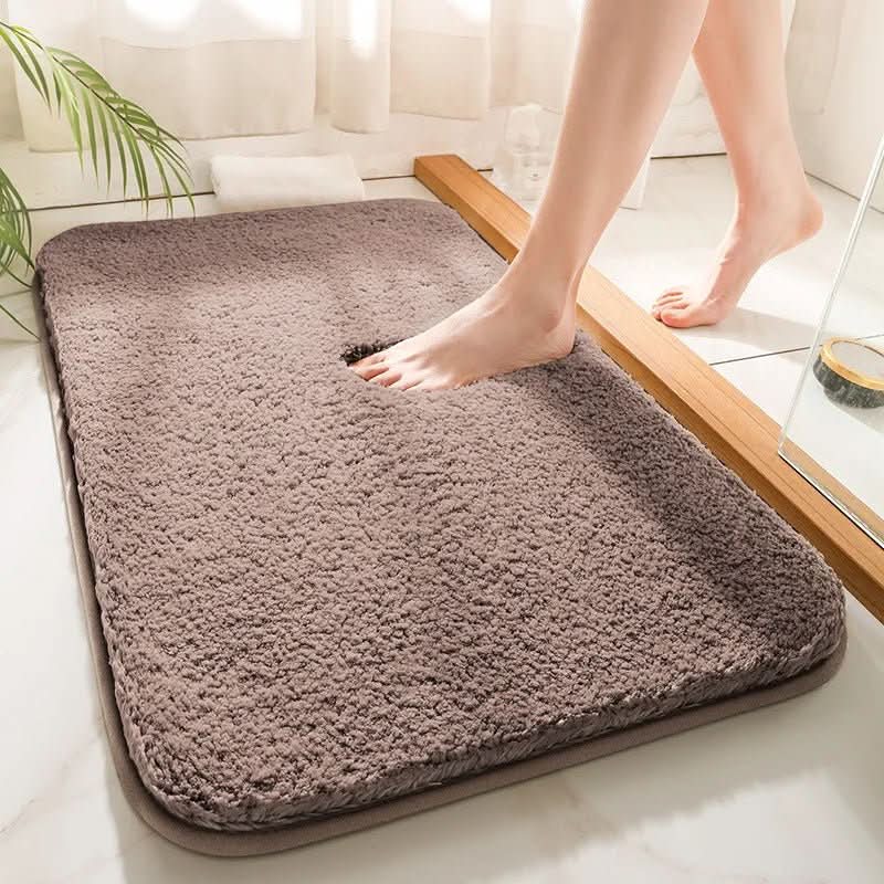 Brown bath mat on a bathtub with a person stepping onto it