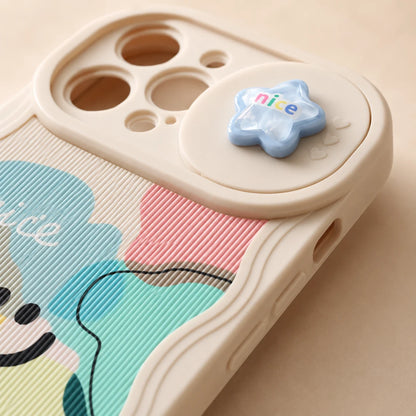 Josh & Tate - CloudPop™ Sliding Lens iPhone Case - Close-up of a beige phone case with a pastel cartoon design and a small blue star charm that says "nice" on a light beige background.