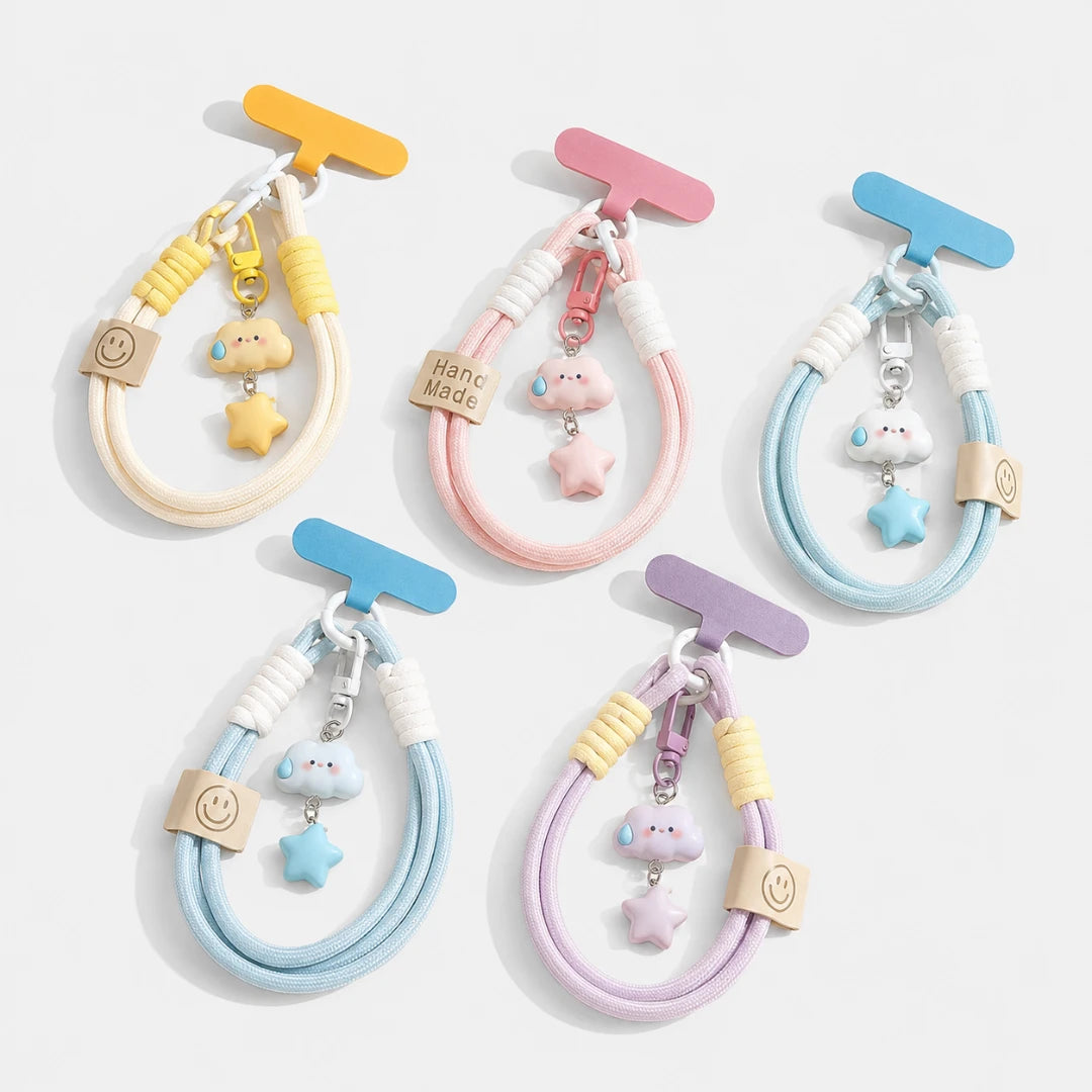 Josh & Tate - CloudStar™ Phone Lanyard - Five pastel-colored elastic hair ties with matching charms, displayed on a light gray background. Each hair tie has a T-shaped plastic hanger, a wooden charm with a smiley face, a small cloud charm, and a star charm.
