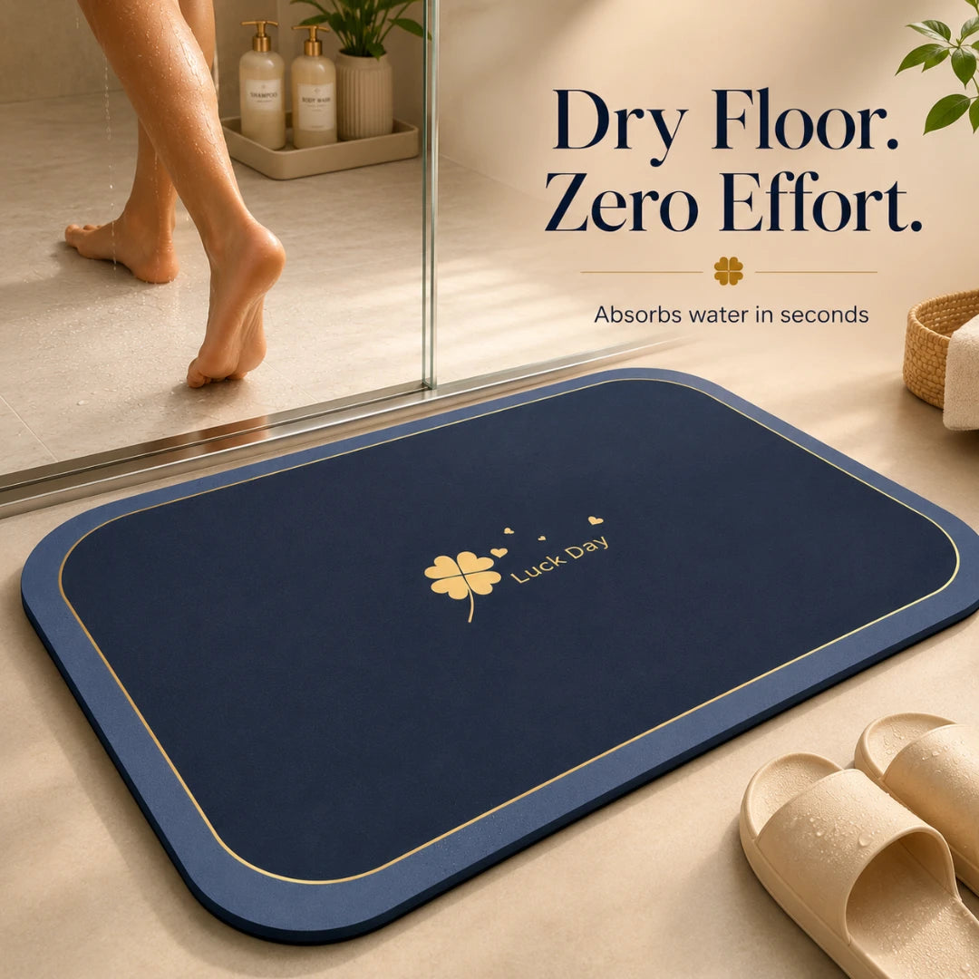 Josh & Tate - CloverDry™ Diatomite Bath Mat - Blue bath mat with 'Luck Day' logo on a bathroom floor, showing text 'Dry Floor. Zero Effort.'