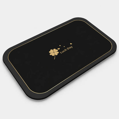 Josh & Tate - CloverDry™ Diatomite Bath Mat - Black mat with gold border and 'Luck Day' logo on a white background