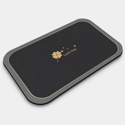Josh & Tate - CloverDry™ Diatomite Bath Mat - Black and gray mouse pad with a four-leaf clover design and 'Luck Day' text on a white background