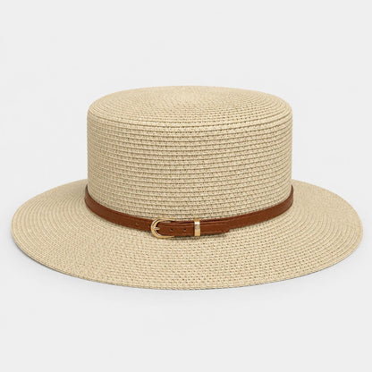 Josh & Tate - CoastBuckle™ Flat-Top Straw Hat - A light beige woven straw boater hat with a brown leather band and a gold buckle, shown against a plain light gray background.