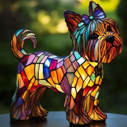 Colorful stained glass dog sculpture with a bow on a dark background