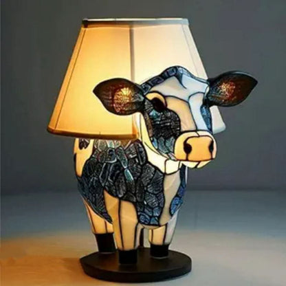 Cow-shaped lamp with a beige shade on a dark background