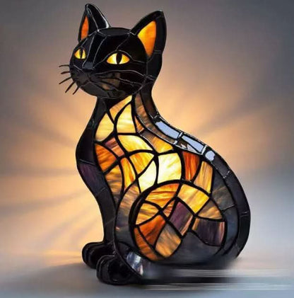 Stained glass cat lamp with a warm glow on a dark background