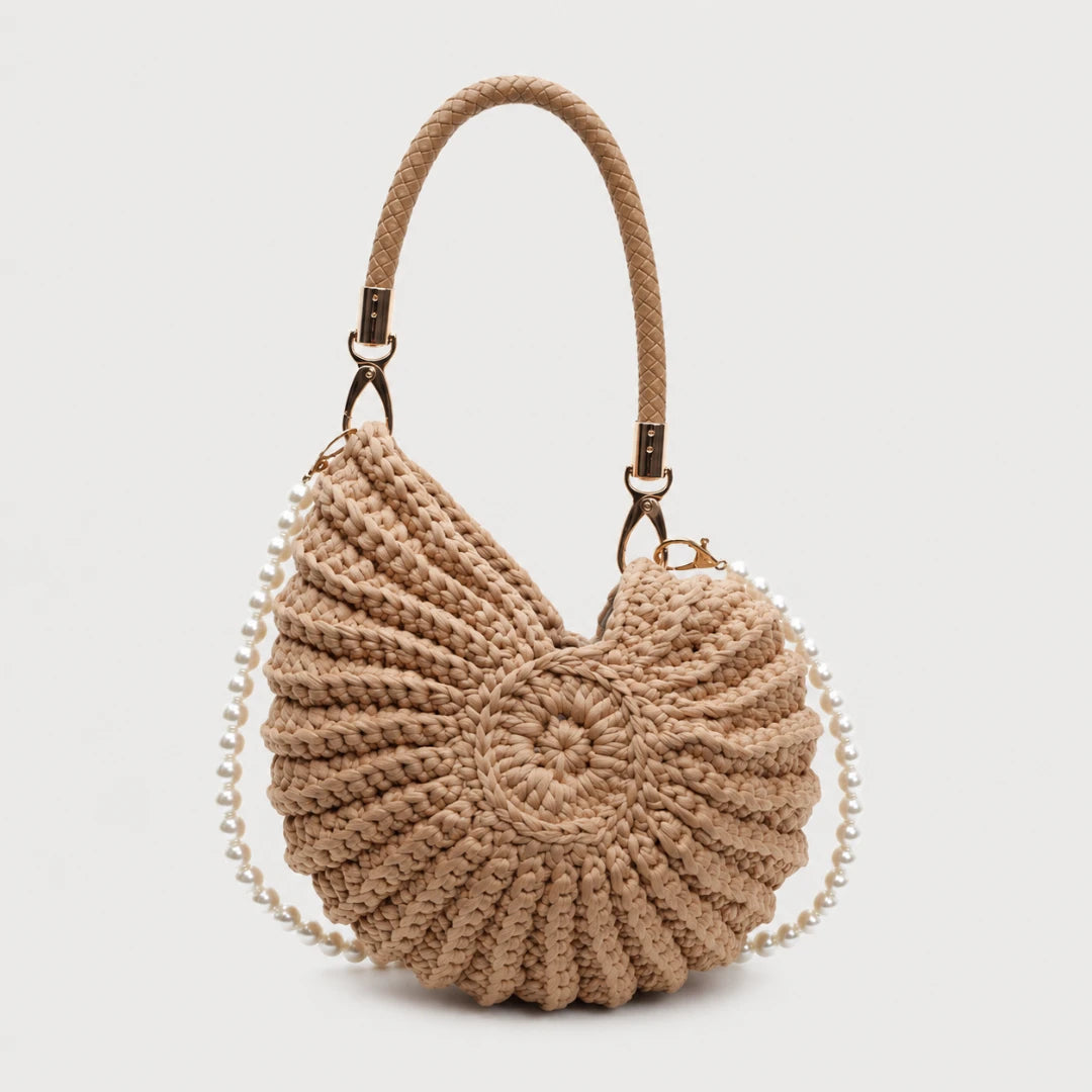 Josh & Tate - ConchKnit™ Pearl Handbag - Beige woven handbag with a chain detail on a light gray background